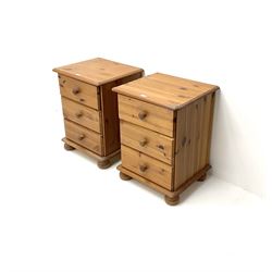 Pair polished pine bedside chests, two short drawers, pad supports 
