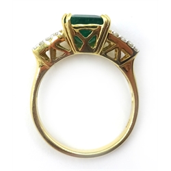  18ct gold emerald ring, with tapered baguette and round brilliant cut diamonds either side, emerald approx 1.2 carat, stamped 750  