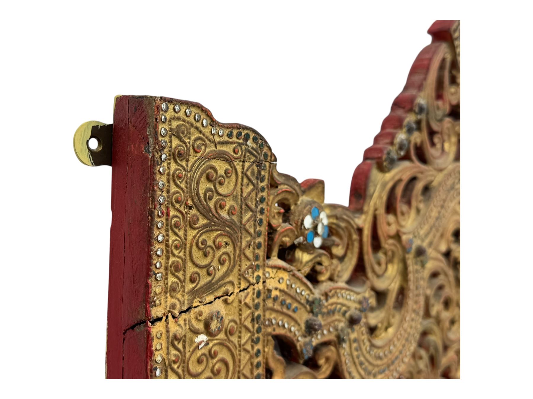 Large North African design carved and painted wall mirror, decorated with floral motifs, pierced foliate scrolls, inset mirrored panels, and colourful painted detailing, enclosing an oval bevelled mirror plate