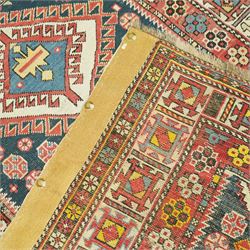 Vintage Caucasian Shirvan hand-knotted rug, indigo field with an arrangement of geometric diamond medallions and stylized tribal motifs within multiple patterned borders, with fringe ends 