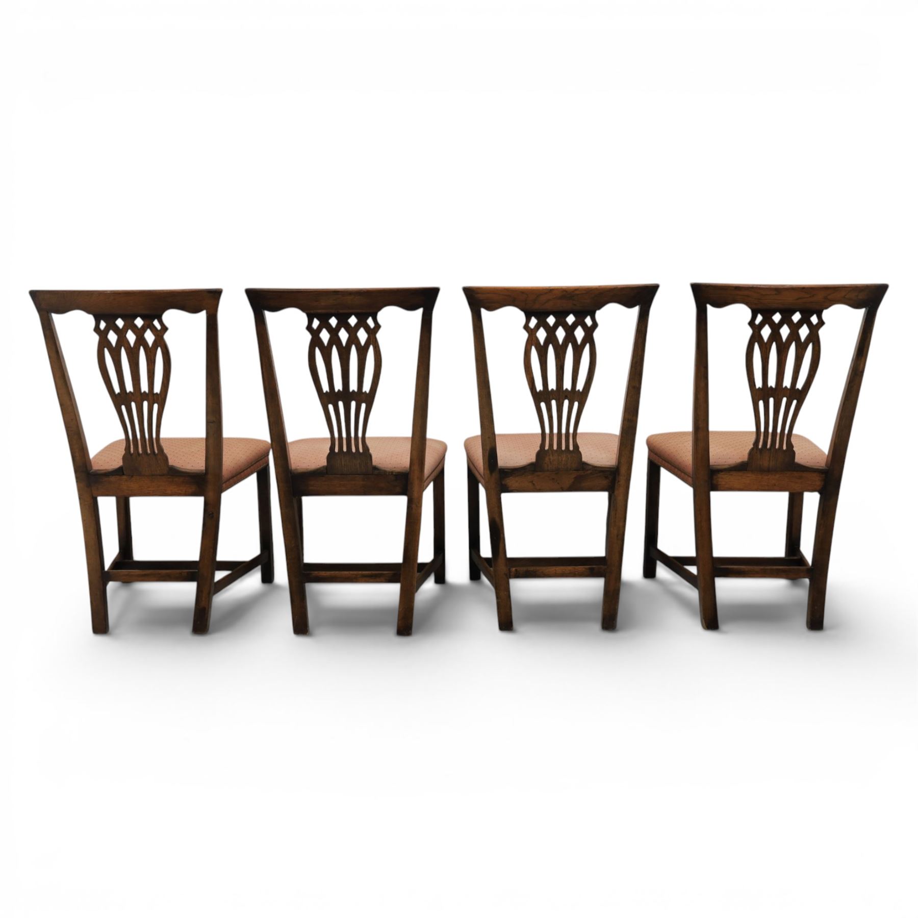 Set of eight George III dining chairs with padded seats, pierced vasiform splat, upholstered seat with brass trim, on square supports with H-stretcher