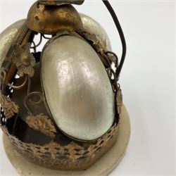 Victorian evening dinner bell, with three mother of pearl shells, floral and grape gilt decoration, and bird finial, raised upon a circular soapstone base with gilt pierced gallery, H14cm
