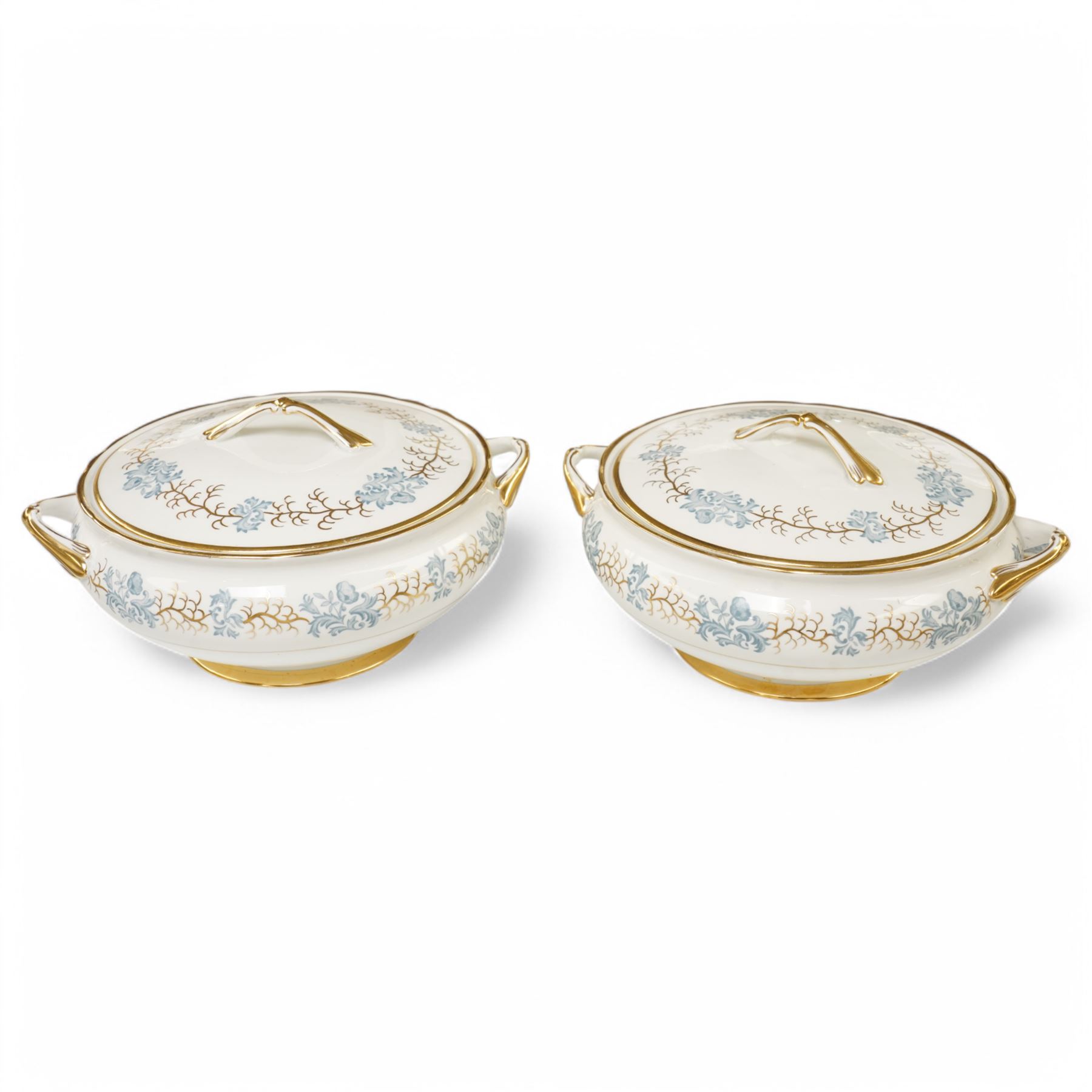 Tuscan Avondale dinner and coffee service for twelve covers with a blue and gilt border pattern comprising  twelve dinner plates, twelve dessert plates, twelve side plates, twelve two handled soup bowls and stands, four vegetable dishes and covers,  four graduated meat plates, sauce boat and stand, twelve coffee cups and saucers and twelve tea plates (106)