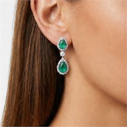 Pair of 18ct white gold emerald and diamond earrings, each stud set with two pear cut emeralds, surrounded by round brilliant cut and baguette cut diamonds, spaced by a single diamond, stamped, total emerald weight approx 4.15 carat, total diamond weight approx 1.50 carat