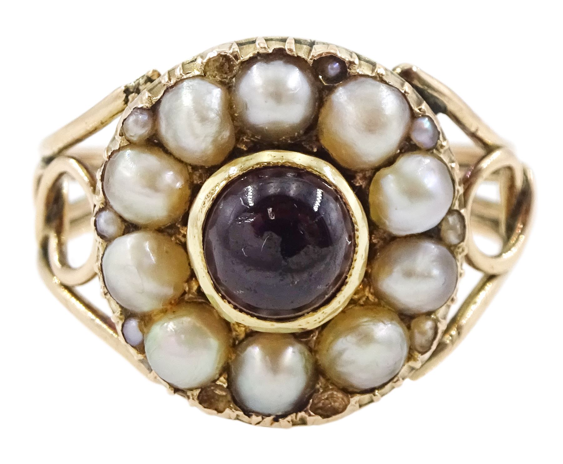 George III 9ct rose gold garnet and pearl mourning ring, single cabochon garnet, with split and seed pearl surround and pierced design shoulders, the back inscribed and dated 1808