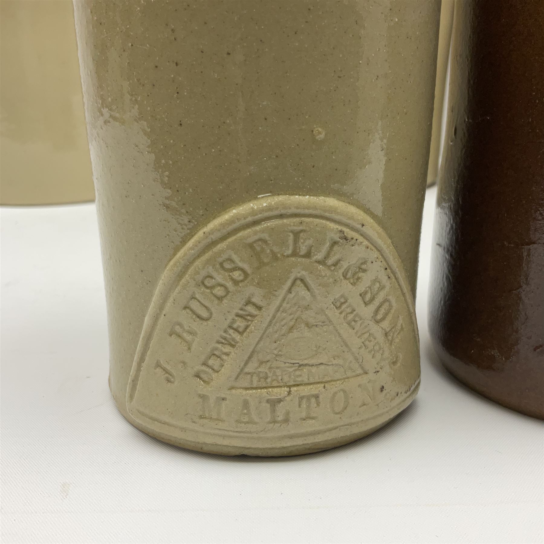 Large 2 gallon stoneware flagon, stamped 'John Soulby Wine Merchant Malton 2 Gall', together with a collection of similar stoneware jars and bottles, largest H40.5cm