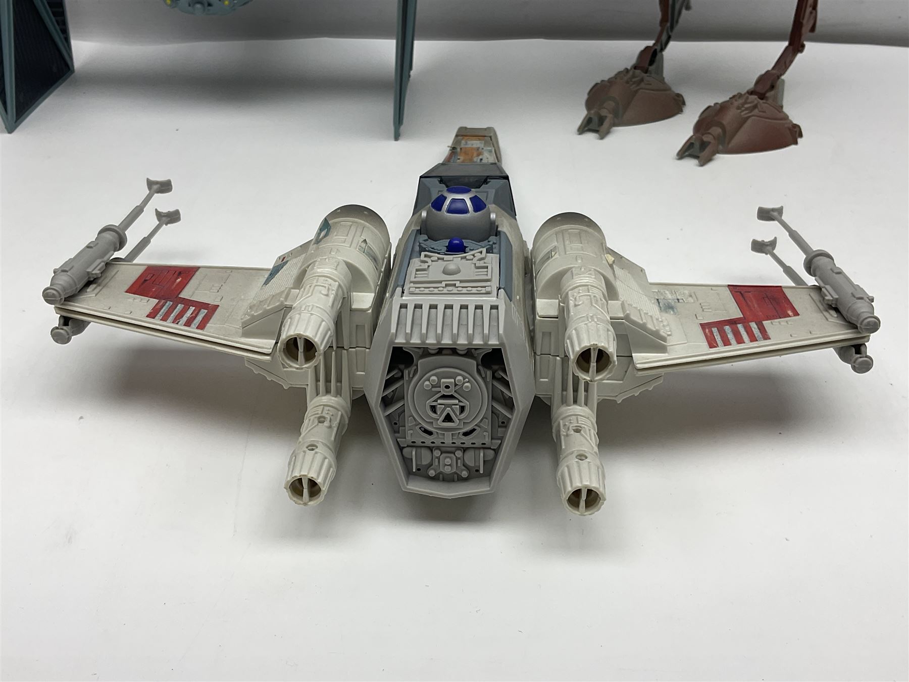 Star Wars - four space/land vehicles comprising Millenium Falcon with hinged top and figures; TIE Fighter; X-Wing Fighter with pilot; and AT-ST 'Chicken Walker' transporter; all unboxed (4)