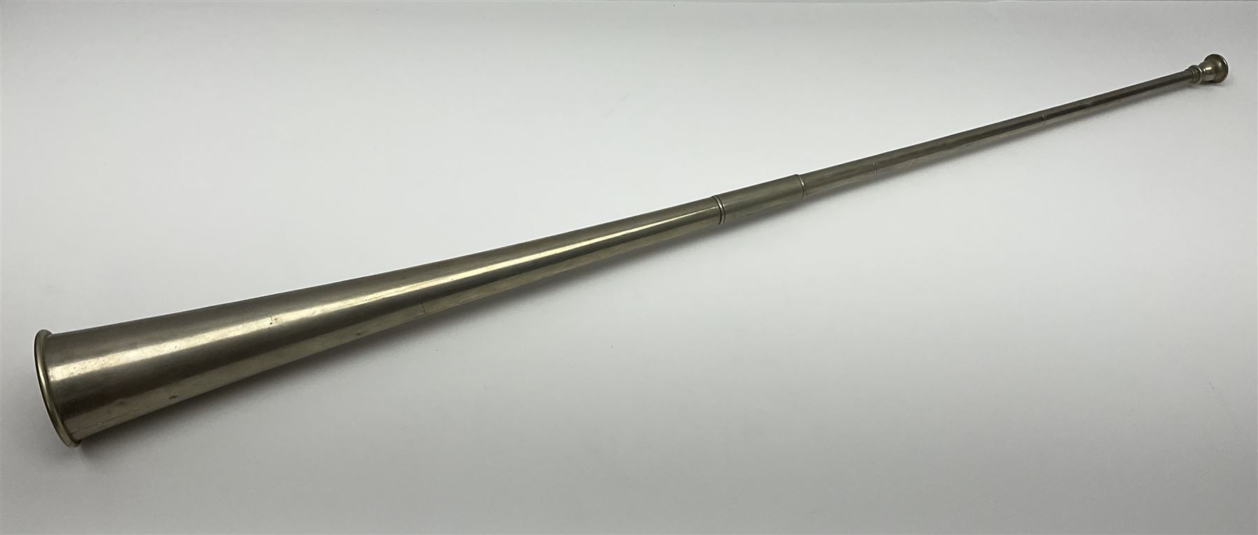 19th century telescopic hunting horn, the bell engraved 'The Beaufort', with makers mark Kohler & Son, makers, 61 Victoria Street, Westminster (from Covent garden) London, in a leather sheath, horn full extended L91cm 