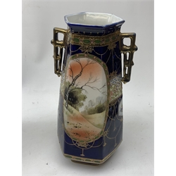 A pair of Japanese Nippon Kinjo vases, of tapering hexagonal form with twin stylised handles, the cobalt blue ground with oval hand painted panels to front and verso depicting landscapes, further detailed with smaller floral bands and panels and heightened with gilt, each with mark beneath, H30.5cm.  