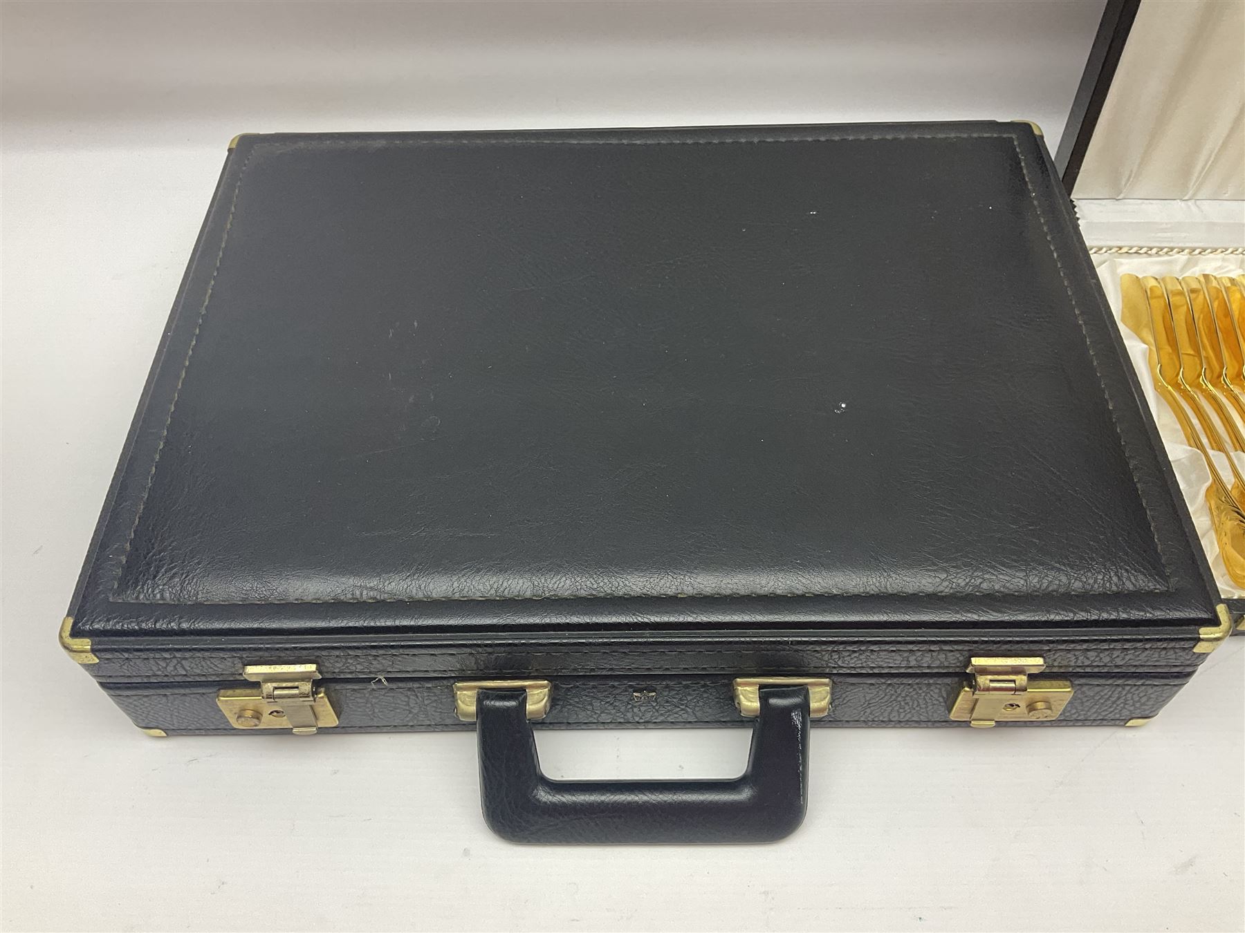 Bestecke Solingen canteen of gold plated cutlery for twelve place settings, including ladle, cake slice and serving spoons, contained within a briefcase, together with a matching set twelve of Bestecke Solingen gold plated fish knives and forks, in fitted case 