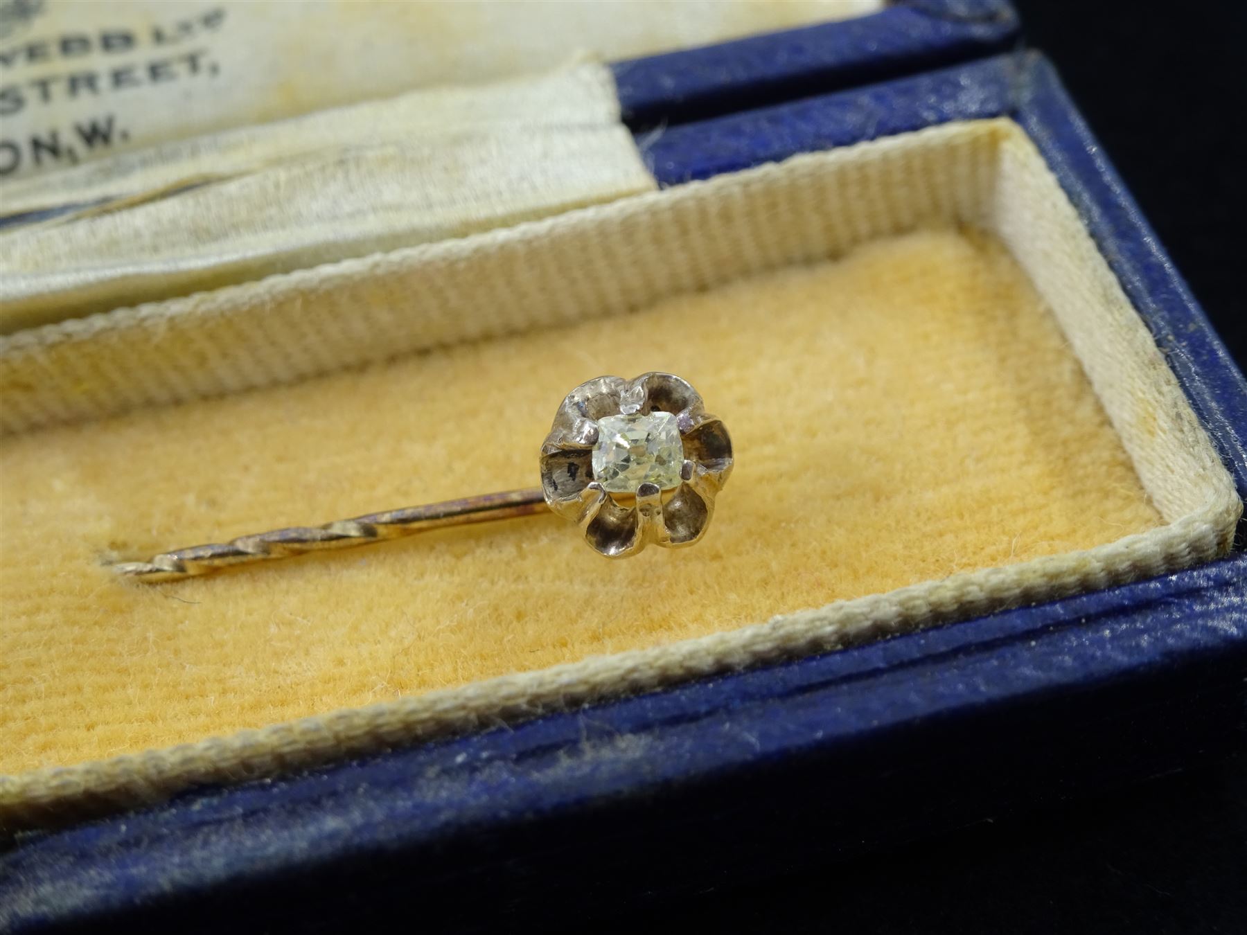 George III silver heart shaped caddy spoon, makers mark IT, Birmingham 1812, gold diamond stick pin, silver cigarette case by Henry Matthews, Birmingham 1906, three silver thimbles and a silver table spoon Fiddle pattern  by John Stone, Exeter 1842