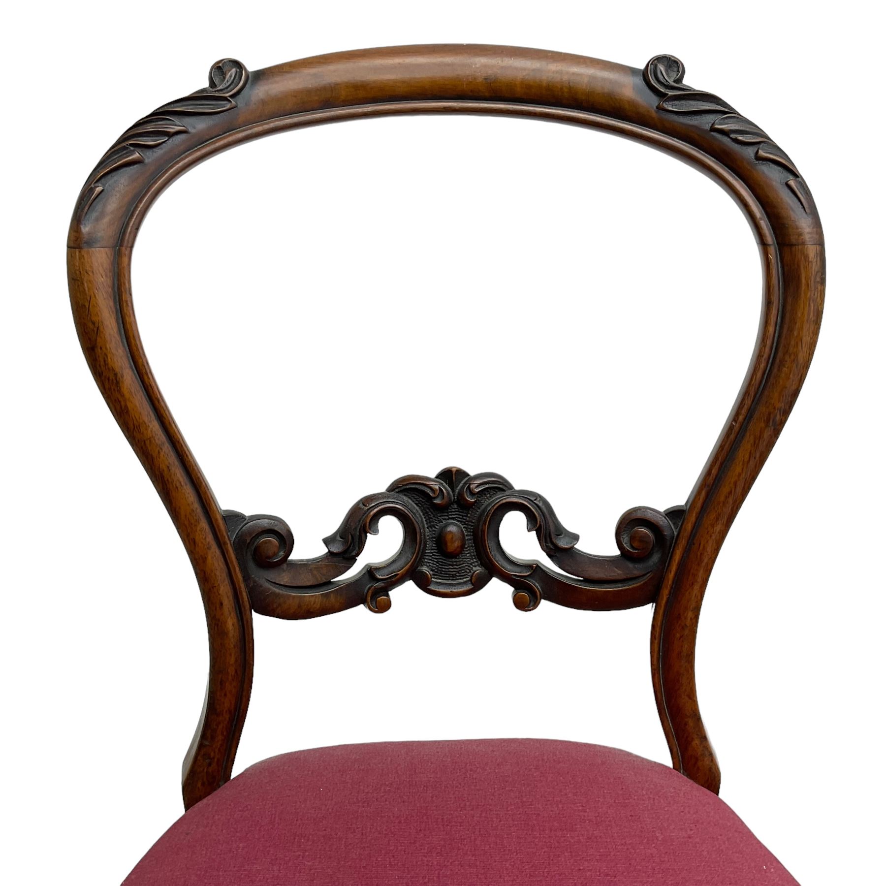 Set of six Victorian rosewood dining chairs, the balloon back carved with foliage scrolls, cartouche carved middle rail with extending scrolls, the seats upholstered in pink fabric, on carved cabriole supports with scrolled terminals 