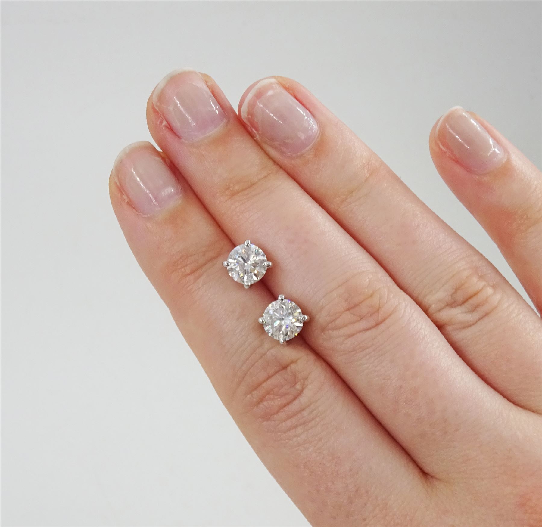 Pair of 18ct white gold round brilliant cut diamond stud earrings, hallmarked, total diamond weight approx 2.05 carat