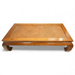 Chinese hardwood low coffee table, rectangular framed top inset with woven cane panel, mitred moulded edge, plain apron, raised on shaped and out-scrolled end supports joined by stretchers