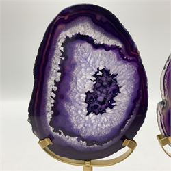 Pair of purple agate slices, polished with rough edges raised upon gilt metal stands