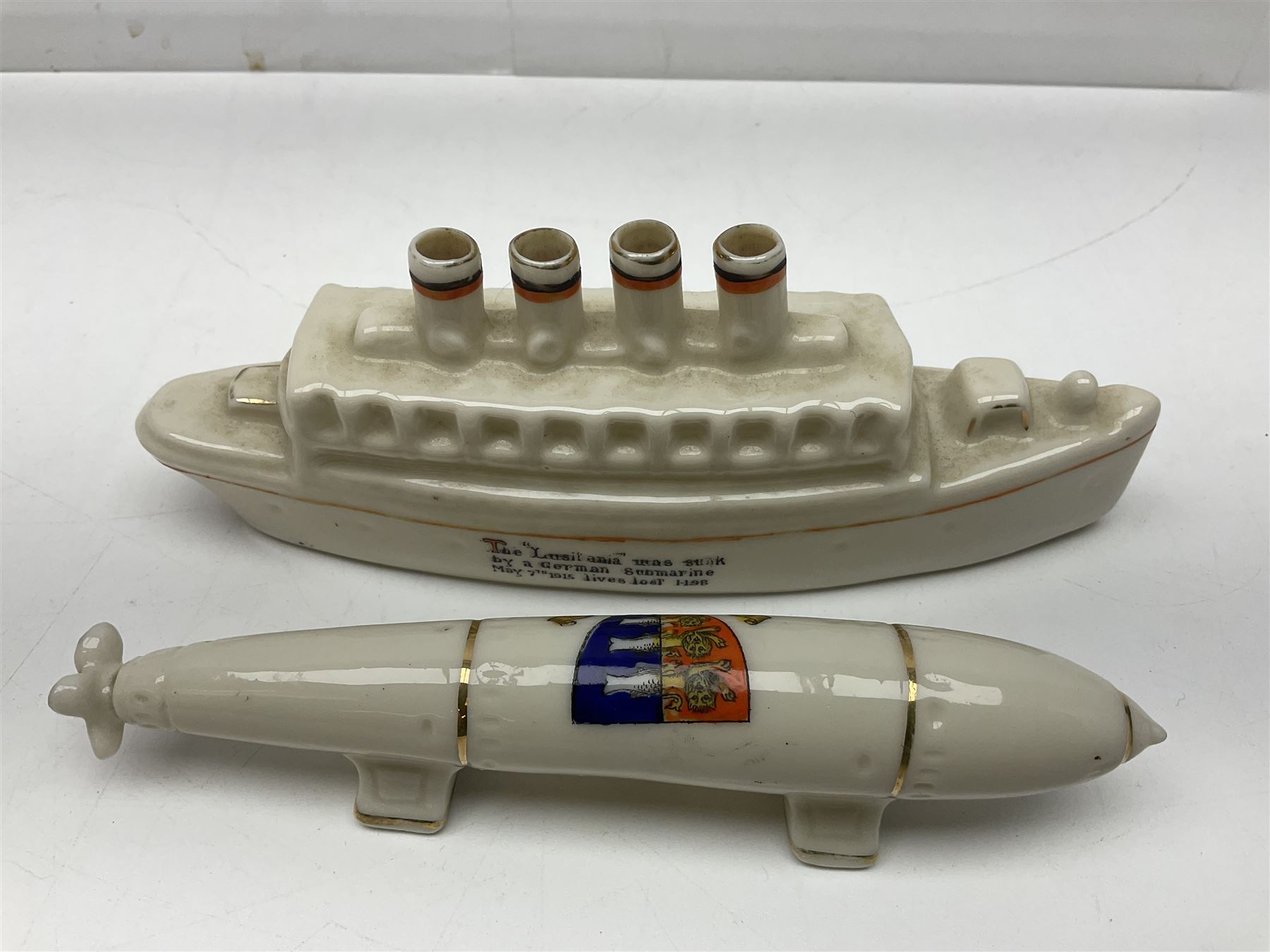 Ten WW1 crested china military models comprising submarine, four ships including Lusitania, four Zeppelins/balloons and an aircraft; various makers including Arcadian China, Swan China, Carlton China, Waterfall, Grafton China etc; various crests including Saint Neots, Great Yarmouth, Tewksbury, Swanage, Simons Town, Hull etc (10)