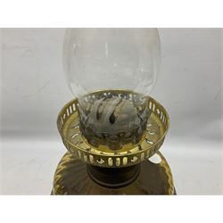 Victorian cast spelter oil lamp, decorated with cherubs and foliate scrolls, supporting a glass reservoir, burner and clear glass chimney, H62cm