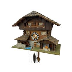 An automaton musical cuckoo clock with a 20th century three weight movement in the form of a Swiss Chalet with a working waterwheel, traditional dial and hands, thirty-hour movement with a cuckoo sounding the hours and half hours on twin bellows, hours followed by one of three tunes played on a musical box and the revolving of the water wheel. With pendulum and weights.




