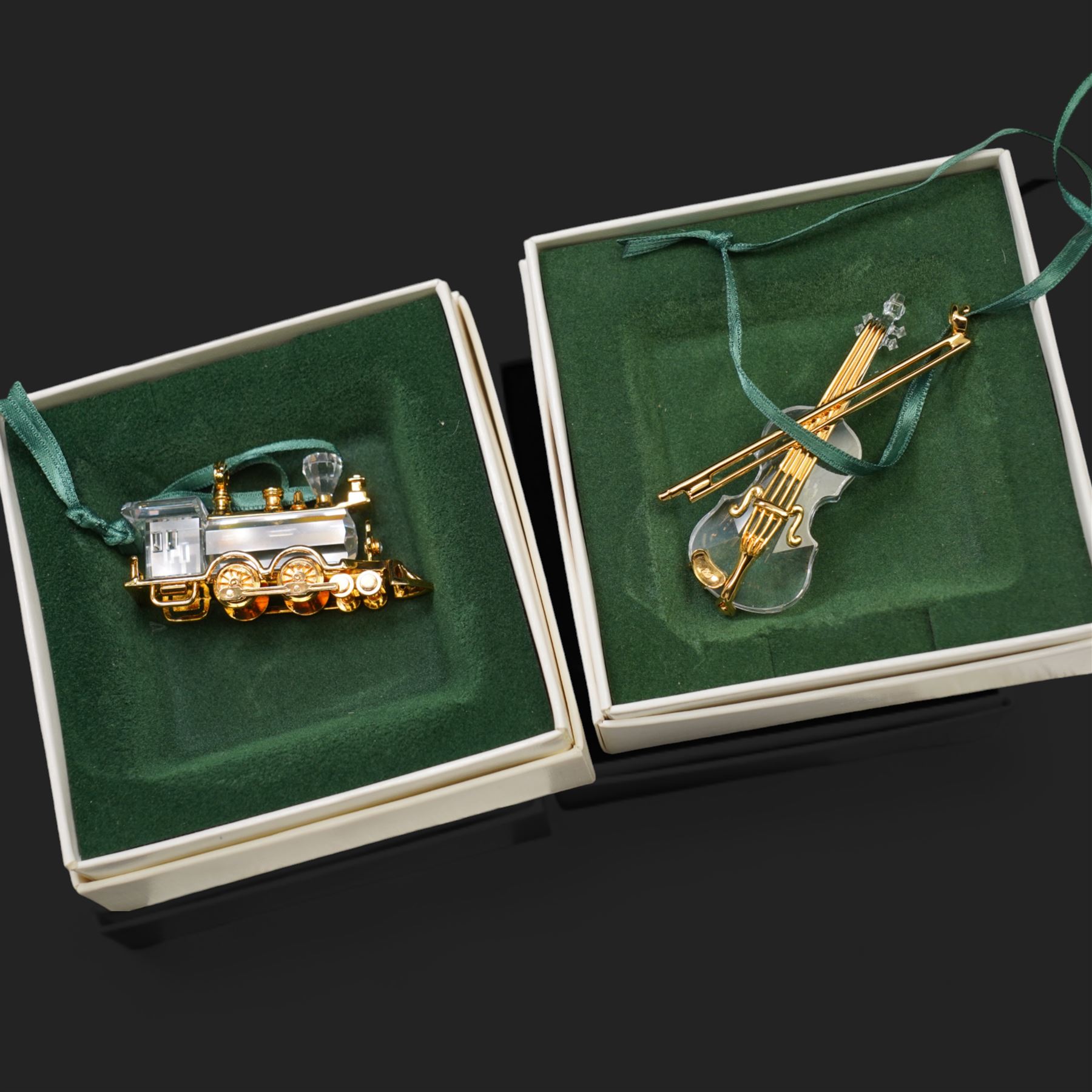 Twelve Swarovski crystal 'Christmas' and 'Crystal' Memories ornaments, comprising Moon, Sun, Boot, Candy Cane, Christmas Wreath, Pinecone and Holly etc, boxed and with sleeves (12)