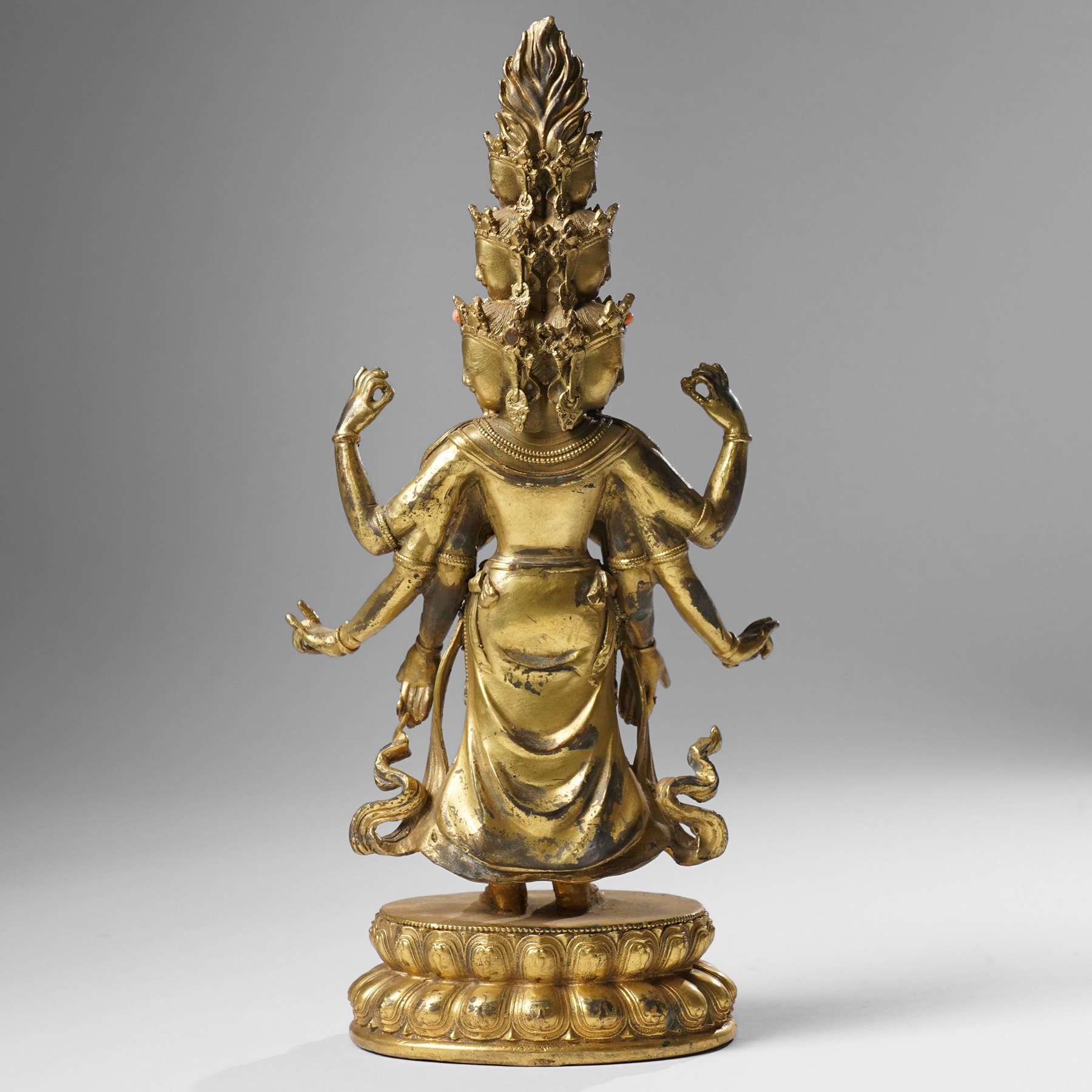 Tibetan gilt bronze figure of Ekadashamukha Avalokiteshvara, standing upright on lotus base, his primary hands in anjali mudra, the other six radiating to the sides, H28cm; together with a gilt bronze figure of Ganesh or Ganapati, H26cm (2)