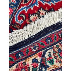 Persian Hamadan indigo ground carpet, the field decorated with central rectangle and outer band, overall floral pattern with cusped central medallion and surrounding leafy branches with palmettes, the border with scrolling branches decorated with further palmettes, within floral pattern guard stripes