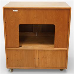Ercol - elm television cabinet, rectangular top with chamfered edges, fitted with a pair of fielded panel cupboard doors with recessed oval pulls, opening to reveal an adjustable shelf and open back for cables, the lower section with drop-front compartment fitted with record slots and wire dividers, raised on concealed castors