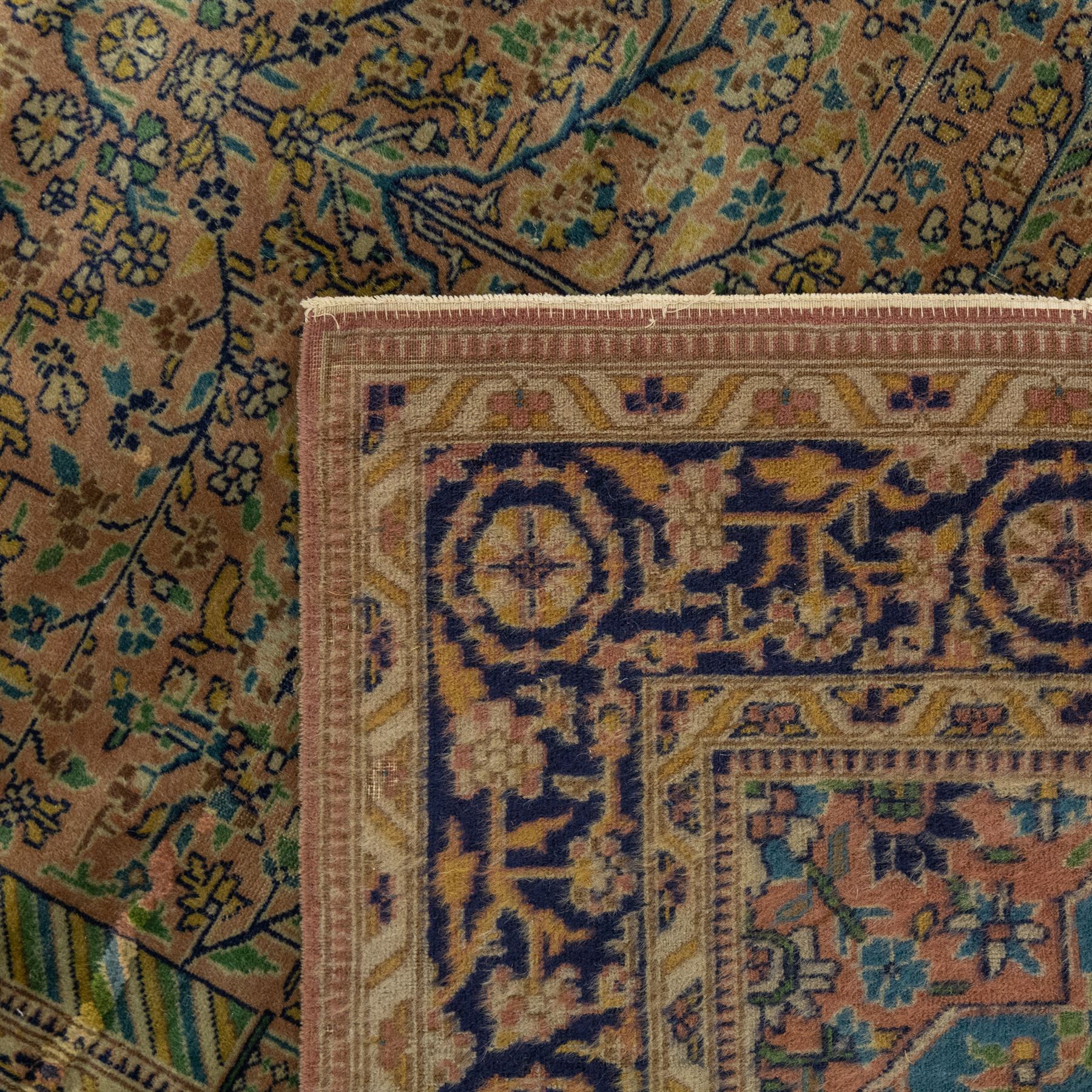 Antique Persian rug, with central tree of life design on a camel field, enclosed by dark blue floral border, with green, blue and ochre detail throughout