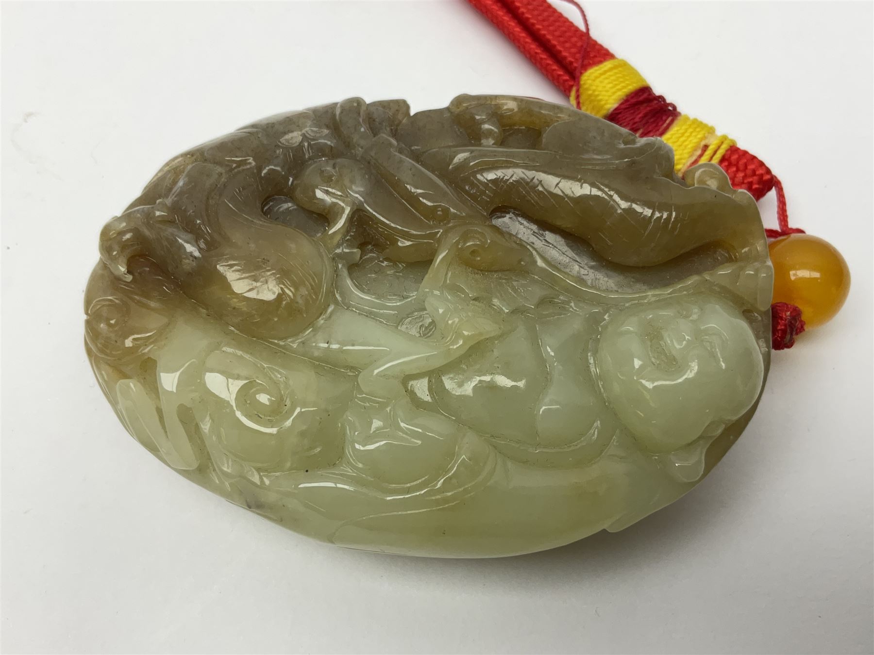 Chinese hardstone carving of a fish amongst coral, with platted rope handle, together with other hardstone and soft stone carvings  