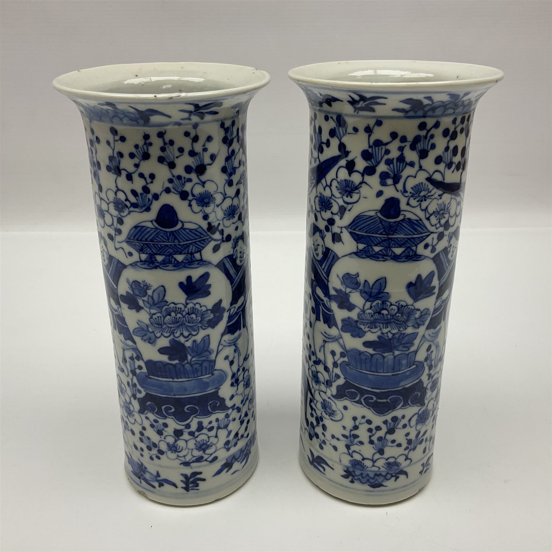 Pair of Chinese blue and white cylindrical vases, decorated with bird and flowers surrounding central figures holding a large vase, H20cm