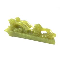 Green stone figural group depicting three lions, upon an inclined base, L21cm