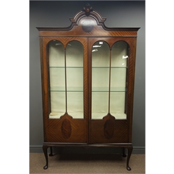  Large Edwardian mahogany display cabinet, projecting cornice, arched pediment with carved fleur-de-lis, two double arched glazed doors, enclosing two glass shelves, shaped apron, cabriole legs, W121cm, H208cm, D36cm  