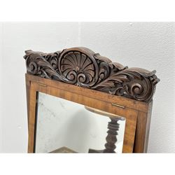 Early Victorian figured mahogany dressing cabinet, the raised shell and scroll carved back lifts to reveal rectangular easel mirror with mahogany band, flat rectangular top with tooled leather inset, slide at each side with matching leather inset, full width drawer above cupboard enclosing a series of five drawers, turned front supports, panelled front, sides and back