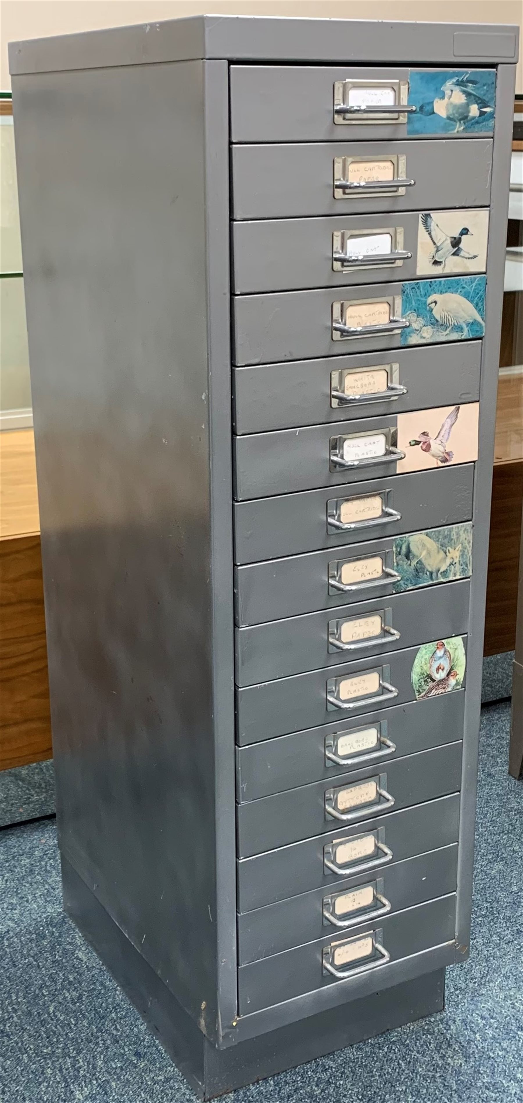 Approximately nine hundred shotgun cartridges, various ages, gauges and makers, contained in grey steel fifteen-drawer cabinet W28cm H94cm D41cm SHOTGUN CERTIFICATE REQUIRED