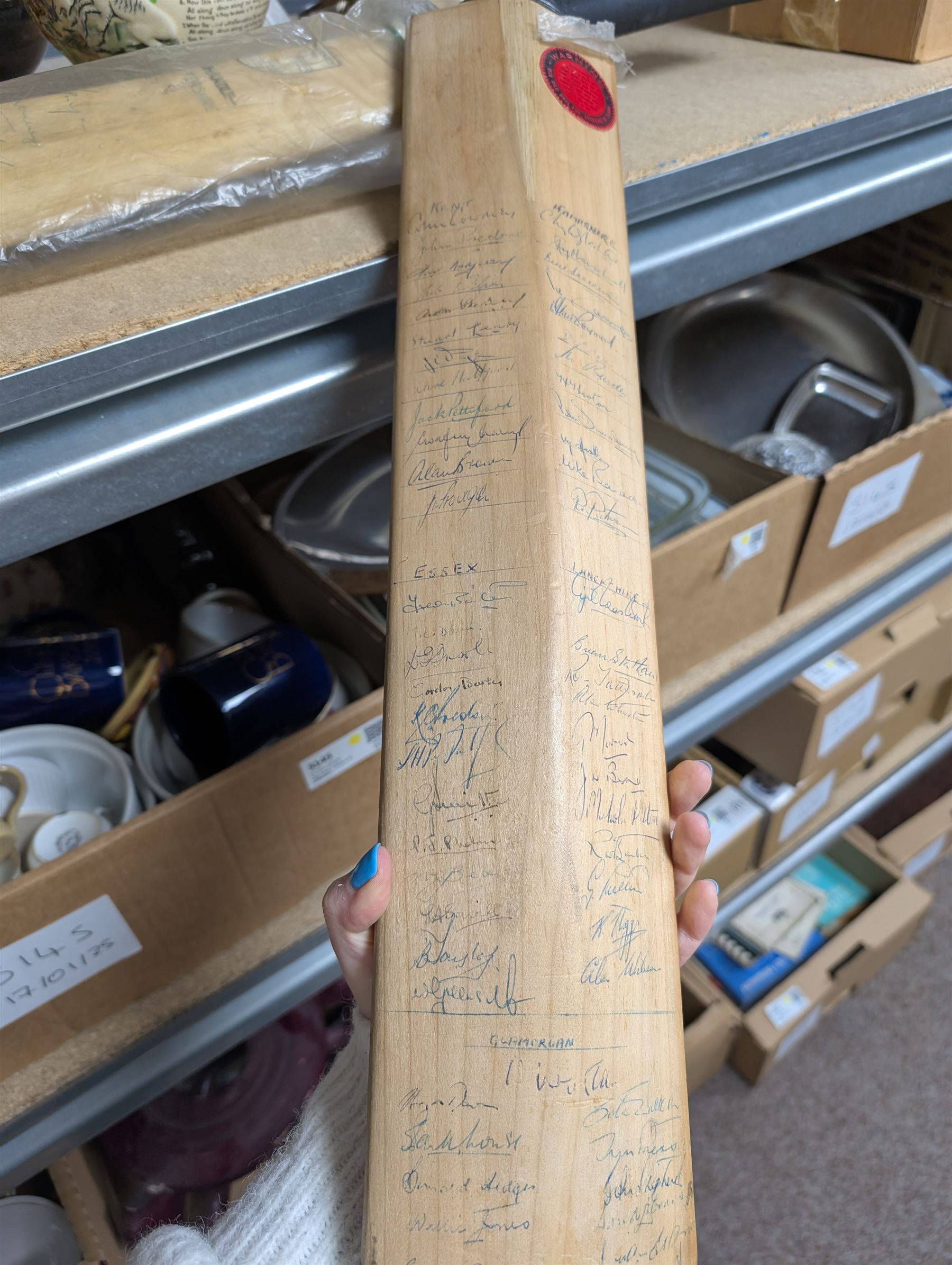Two signed cricket bats, with signatures including Colin Cowdrey