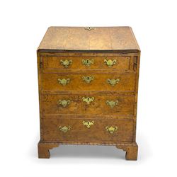 George III figured walnut bureau, fall-front enclosing central cupboard, six pigeonholes and six drawers, fitted with four graduated cockbeaded drawers, on bracket feet