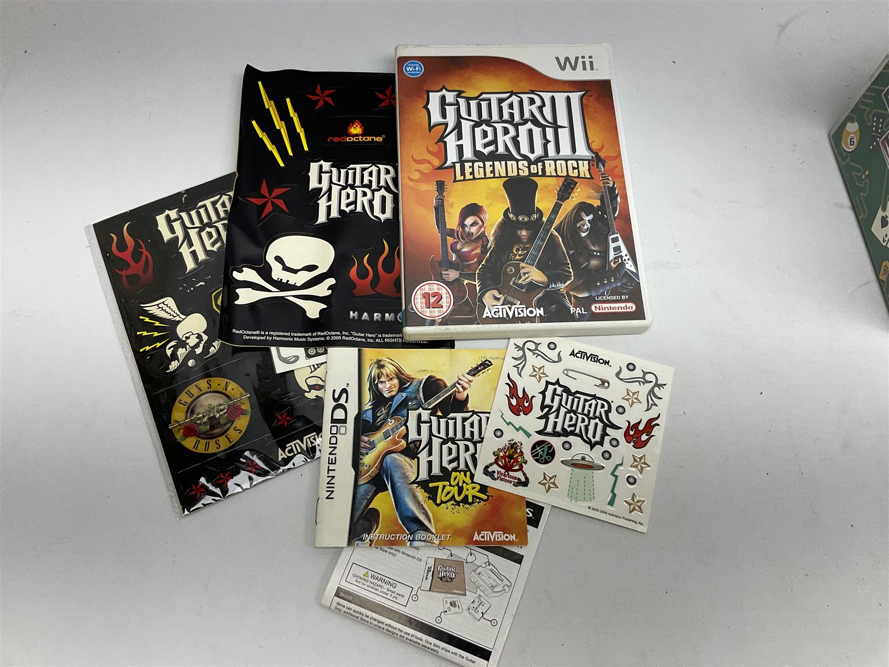 Nintendo Wii console, four controllers with cases and four nunchucks, Wii sensor bar, balance board and dance mat. Guitar hero wireless guitar for Wii and Redoctane wired guitar. Nintendo DS lite handheld gaming console, console and game cases and Guitar Hero Redoctane Guitar Grip. Selection of Nintendo Wii and Nintendo DS lite games to include Super Mario Galaxy, Guitar Hero, Wii Fit, Legend of Zelda games etc. Archos AV400 Series pocket video recorder with accessories, cradle and remote, in three boxes