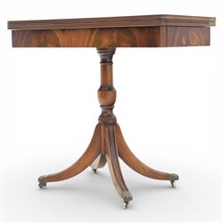 Victorian design mahogany card table, rectangular top with swivel and fold open action, revealing a baized lined interior, raised on turned baluster column, with reeded legs terminating in brass paw castors 