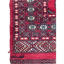 Turkmen Tekke Bokhara rug, red ground and decorated with Gul motifs, repeating multi-band border, signed on corners 