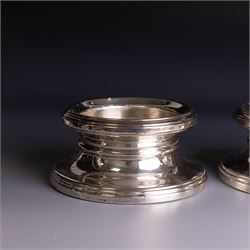 Pair of modern silver mounted candle holders, of circular stepped form, hallmarked Broadway & Co, Birmingham 2006, H5.5cm, D11cm