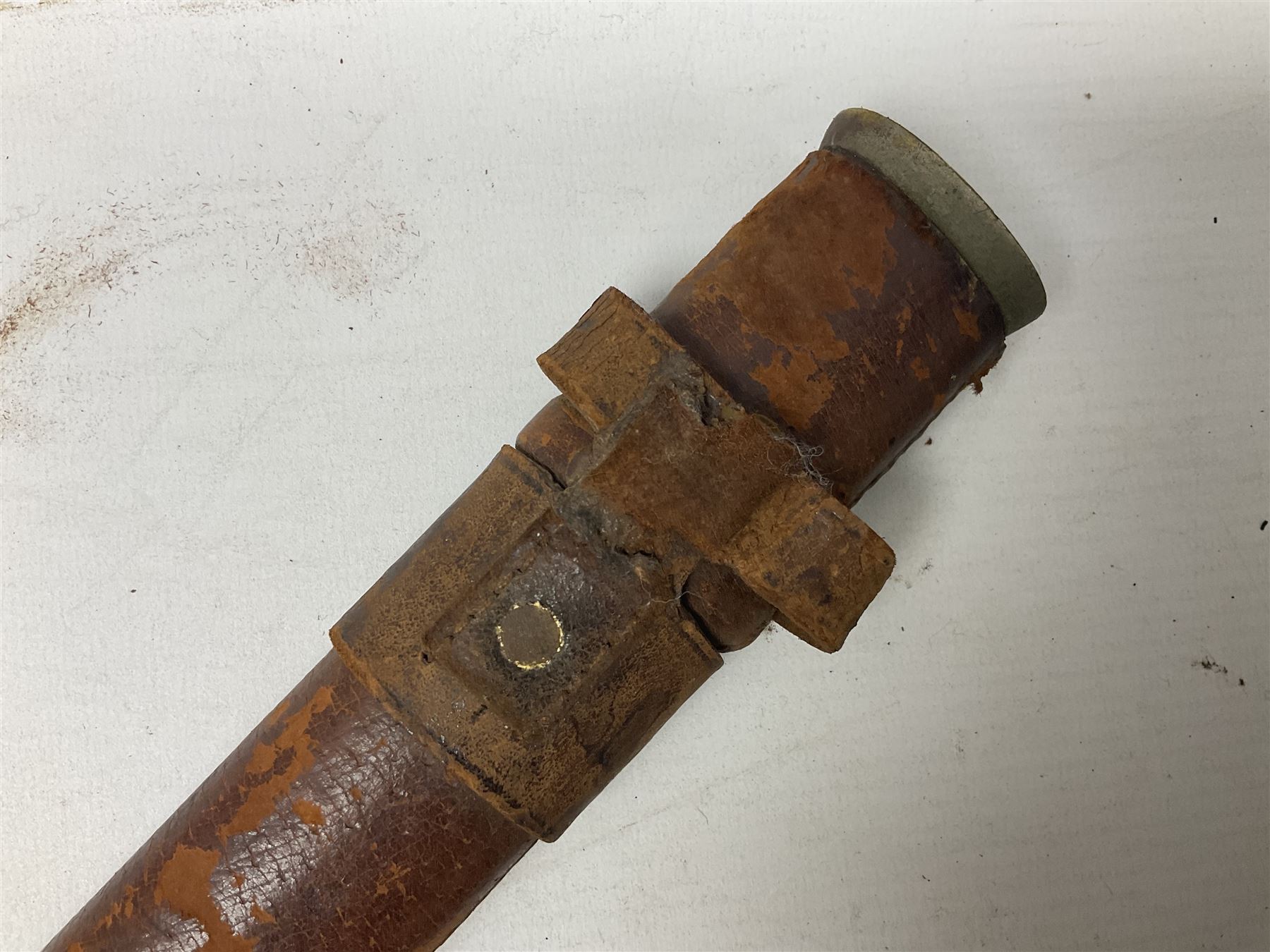 George V 1897 pattern Infantry officers sword, the 82cm single fullered blade with traces of etched detail and George V crown cipher, the ricasso marked Hawksworth Sheffield, pierced half basket hilt with George V cypher, wire-bound fish-skin grip with brass pommel and backstrap; in leather scabbard L102cm overall; together with two sectional gun cleaning rods; swagger stick made of leather strips etc