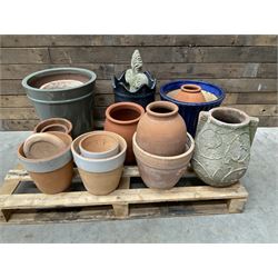 A quantity of various terracotta and glazed planters