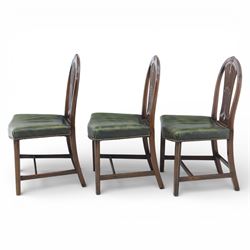 George III style set of six mahogany dining chairs, the arched backs with pierced and carved vase splats beneath carved husk and patera detail, drop-in upholstered seats covered in green leather with brass studded edging, raised on square section legs united by plain stretchers