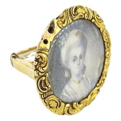 19th century gold portrait ring, set with a circular miniature of a young woman in 18th century dress on ivory, under a glazed panel, within a gold scroll frame and pierced gallery. This lot has been registered for sale under Section 10 of the APHA Ivory Act