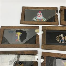 Ten 19th century wooden framed glass animated magic lantern 'slipping' slides of comical figures and animals including one double action of Chinese acrobats L18cm (10)
