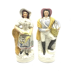 Pair of Victorian Staffordshire flat-back figures of a fishgirl and boy, each depicted standing with a net and holding a basket of fish H33cm (2)
