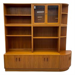 G-Plan - teak three-sectional wall display unit, fitted with raised display cabinet enclosed by two glazed doors, two double cupboards, bowed corner section fitted with shelves and cupboard