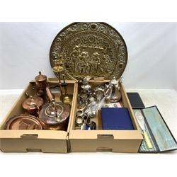  A group of assorted metalware, to include a small selection of silver plate, including three teapots, a milk jug, twin handled sucrier, various cruets, cased and uncased flatware, a large embossed brass wall charger, a pair of brass candlesticks, a small brass box, two copper kettles, a copper chocolate pot, etc.   