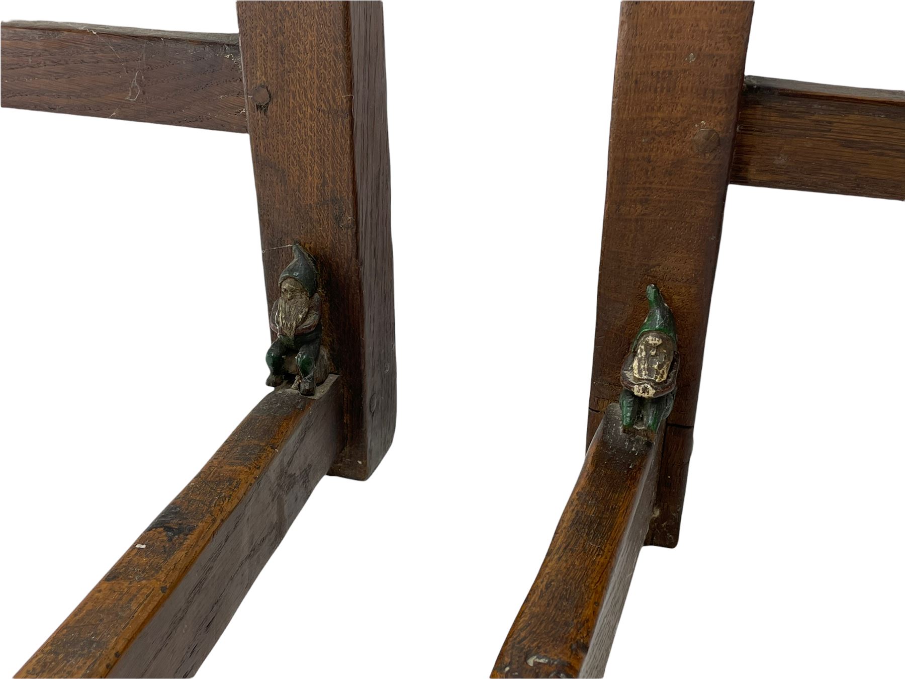 'Gnomeman' set of three oak dining chairs, panelled backs over curved seat rails with drop in rope rush seats, turned front supports with collar joined by plain stretchers, two with carved seated gnome figures, painted

Provenance - This collection of early 'Gnomeman' furniture comes to us directly from the Whittaker family. The pieces were made by the vendor's father Thomas Whittaker in the 1930/40s for his own use. During this time, he lived in York and made items for himself and friends. Whittaker adopted the gnome as a signature and trademark after his move to Littlebeck, Whitby.