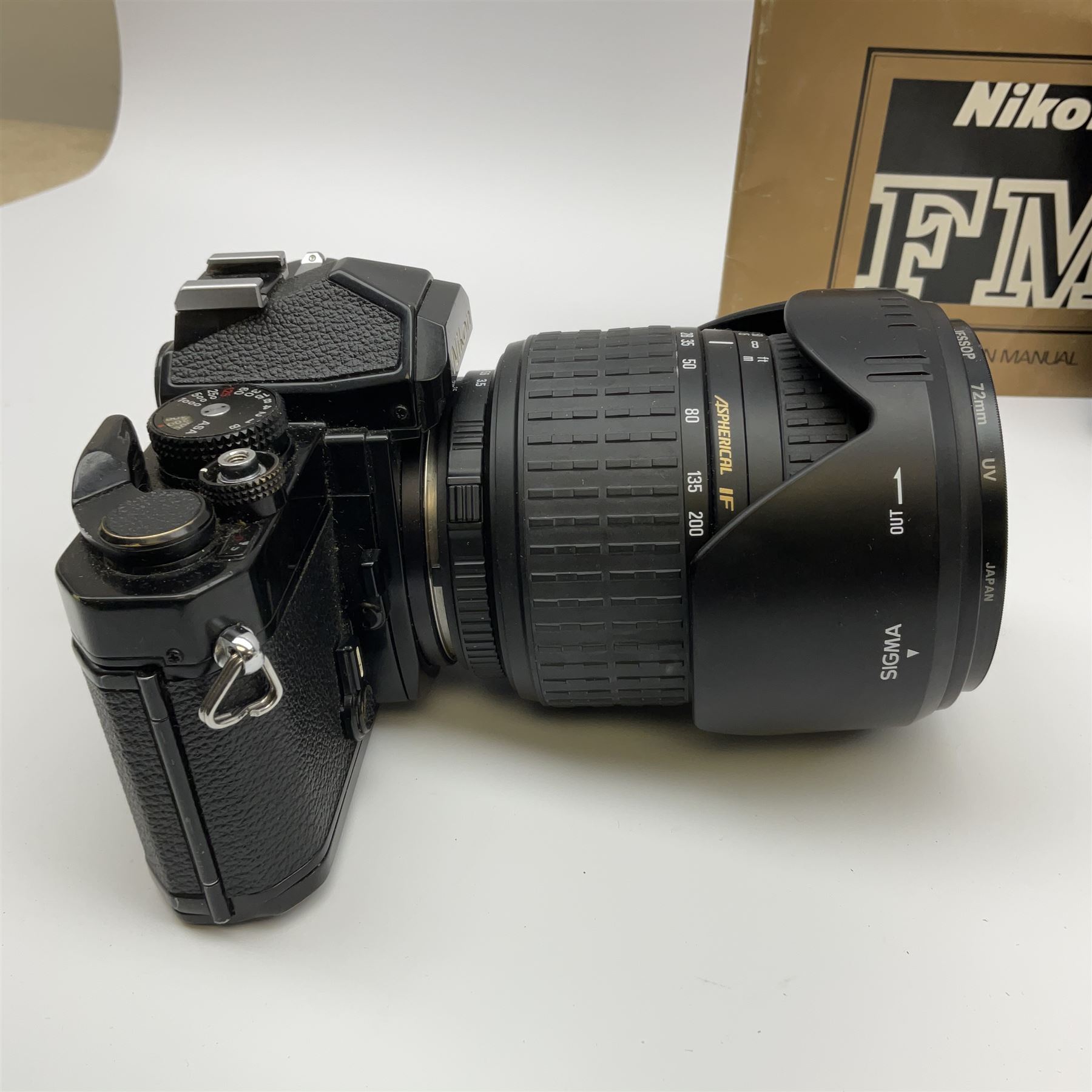 Nikon FM 35mm SLR camera body, Sigma 28-300mm 1:3.5-6.3 lens, Cosina 100mm 1:3.5 macro lens, two macro adaptors, instruction manual, Nikon 'Lite-Touch zoom' 35mm camera, and three relating carrying cases
