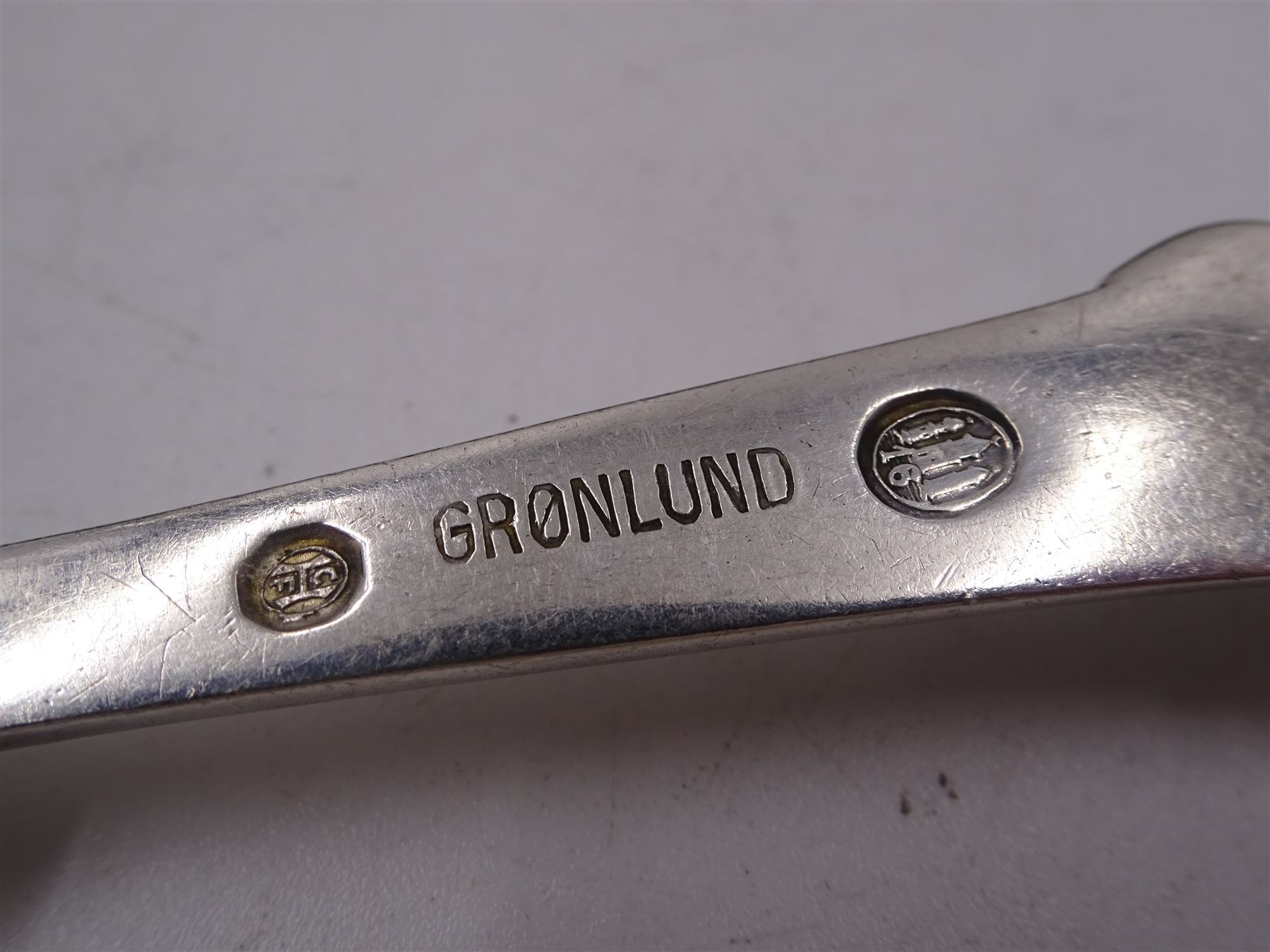 Collection of nine Scandinavian silver spoons, including  early 20th century Danish dessert spoon and three table spoons, each with bead and scroll decoration, stamped with three-tower mark and dated 1916, maker's mark Gronlund, assayer Christian F Heise, together with Norway souvenir spoon, stamped 830s and a Danish commemorative spoon, dated 1910 etc